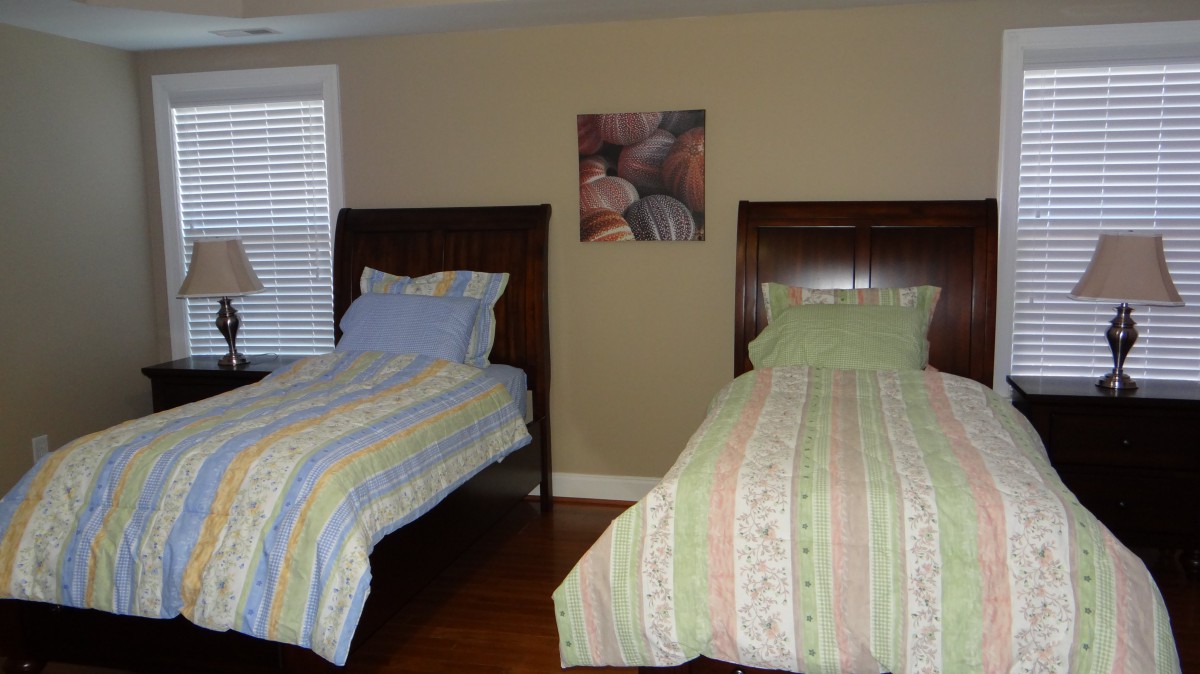 A cozy bedroom with twin beds featuring patterned bedding.