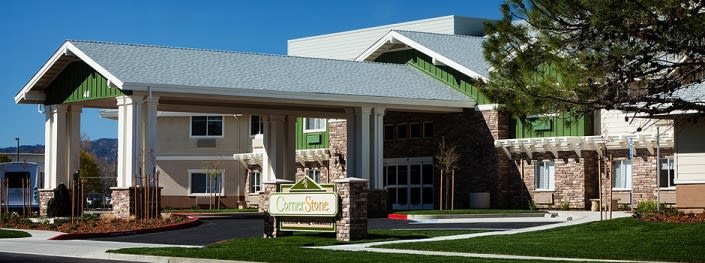 A modern commercial building with a prominent entrance and signage.
