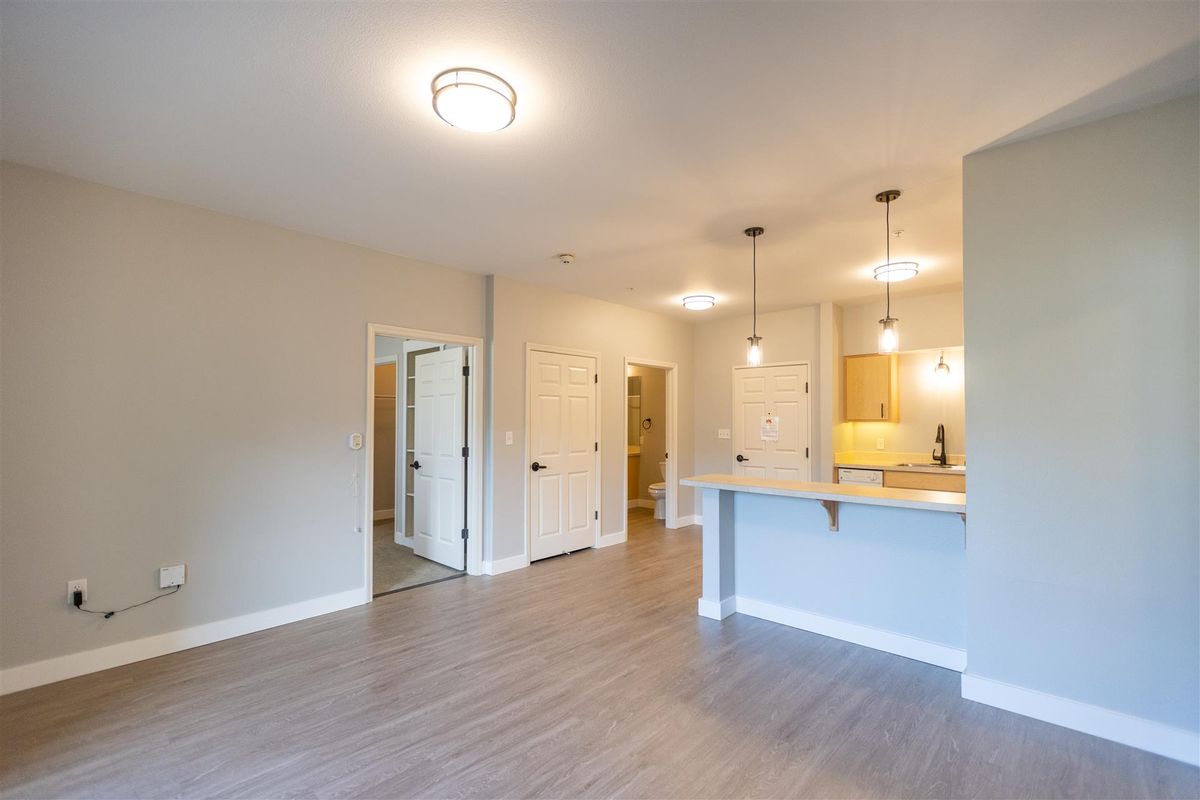 Modern apartment with an open floor plan connecting the kitchen and living area.