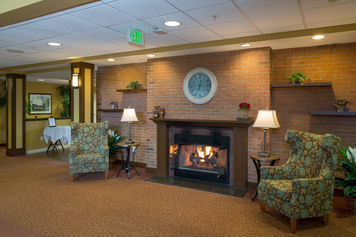 A cozy lobby with a fireplace and comfortable seating arrangements.