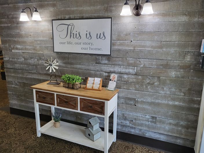 A rustic entryway decorated with a wooden console table and cozy wall art.