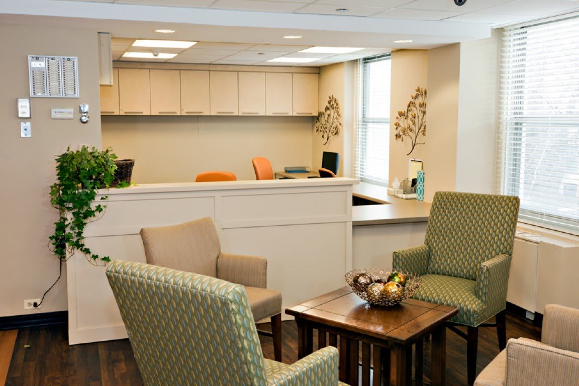 A cozy reception area with comfortable chairs and a welcoming desk.