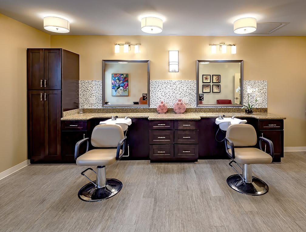 A modern hair salon interior with styling chairs and mirrors.