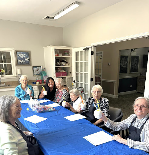 A joyful gathering of seniors enjoying a crafting session at the community center.