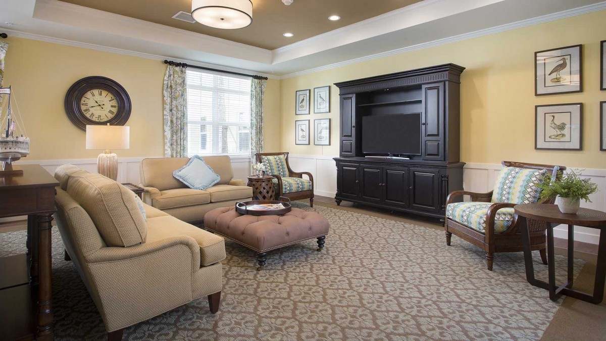 A cozy and stylish living room with elegant furniture and a large entertainment center.