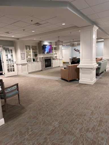 A spacious and inviting lobby area featuring comfortable seating and a modern fireplace.