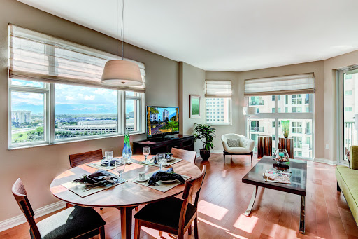 A bright and modern living space featuring a dining area with windows that offer a scenic view.