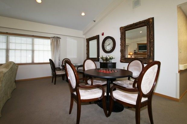 A cozy dining room with elegant furniture and decor.