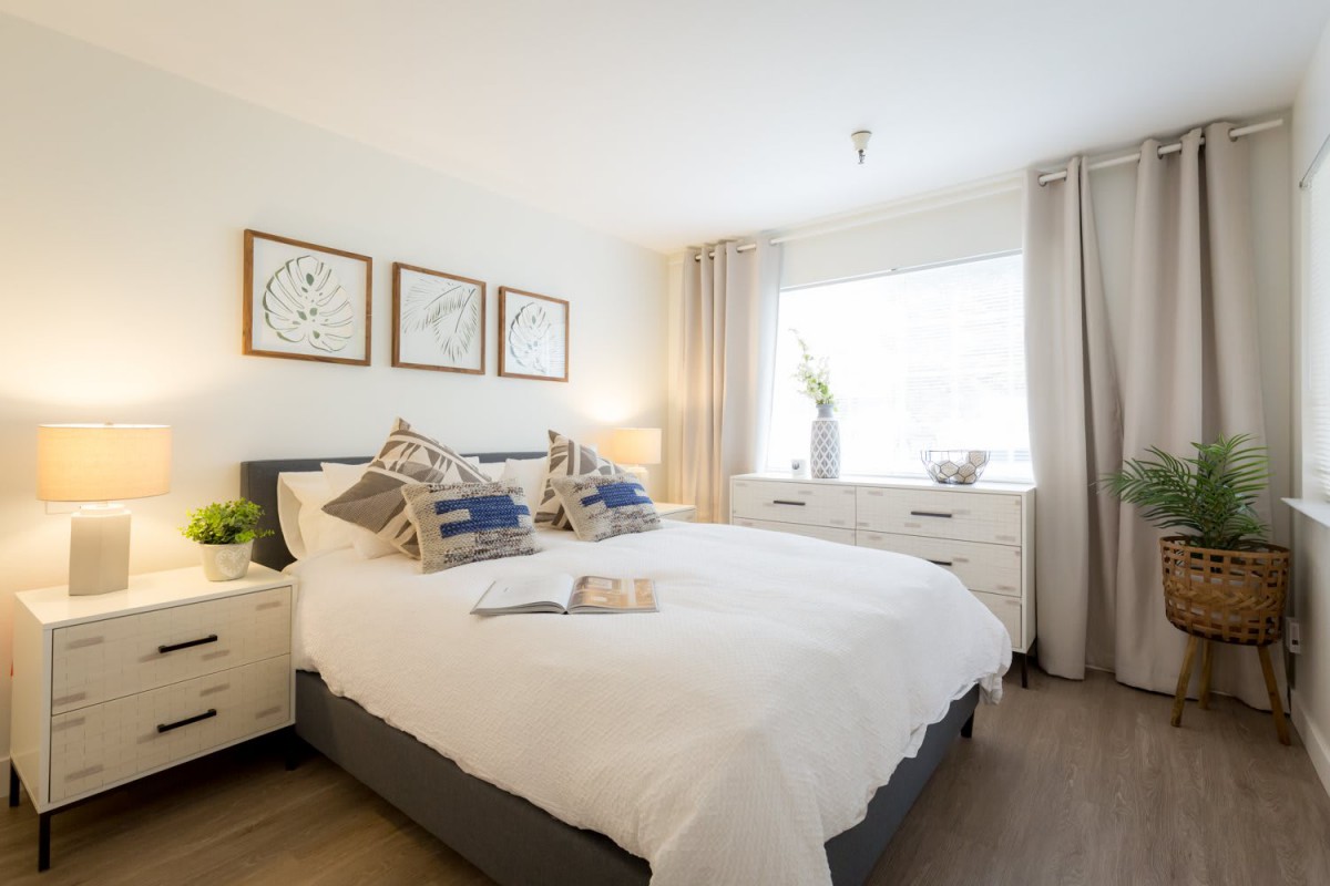 A modern and cozy bedroom with stylish decor and ample natural light.