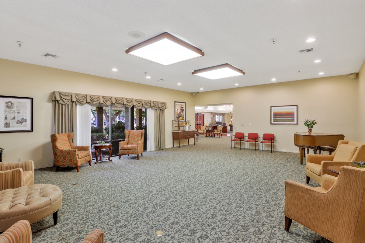 A spacious and well-lit lobby with comfortable seating areas and carpeted flooring.