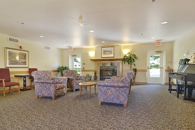 A cozy living room with comfortable seating and a fireplace.