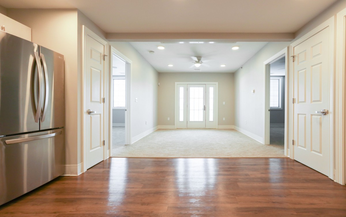 A bright and spacious living room with wooden flooring and a modern design.