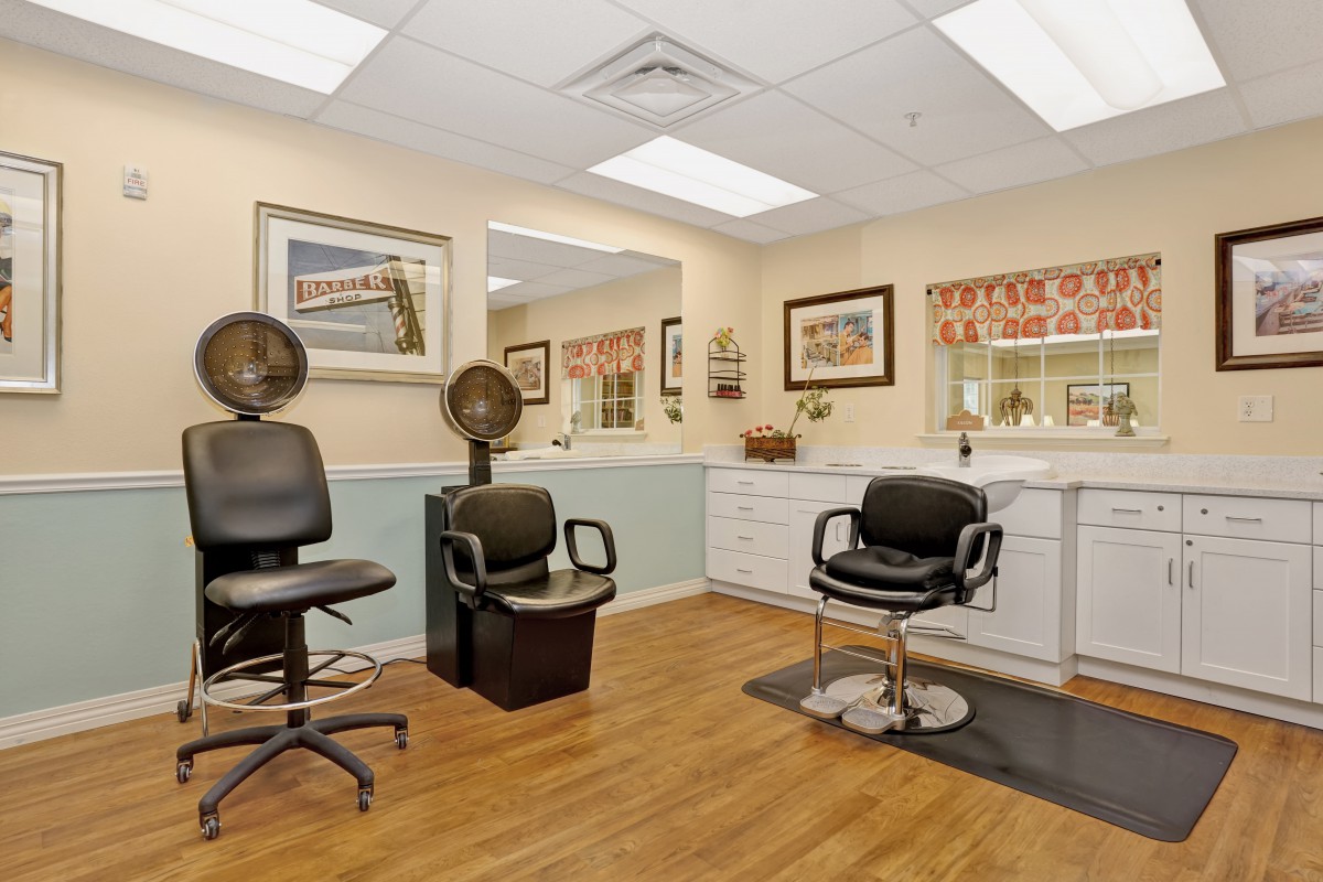 A well-lit hair salon interior with styling chairs and mirrors.