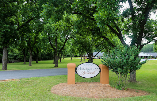 A welcoming sign surrounded by lush greenery, indicating the entrance to a community.