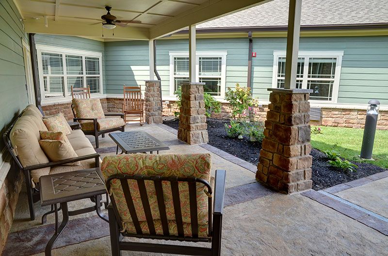 A cozy patio with comfortable seating and a view of the garden.