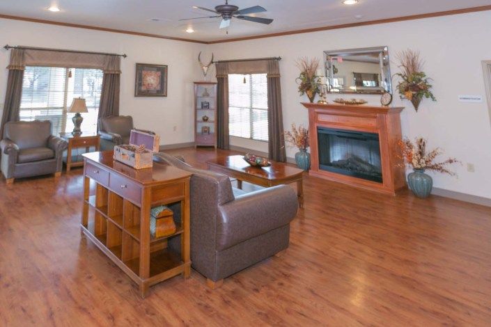 A cozy living room featuring a fireplace, hardwood floors, and comfortable seating.