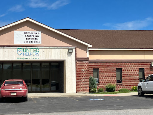 Exterior view of a medical facility with clear signage under a blue sky.