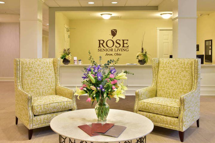 A welcoming reception area with elegant seating and a floral centerpiece.