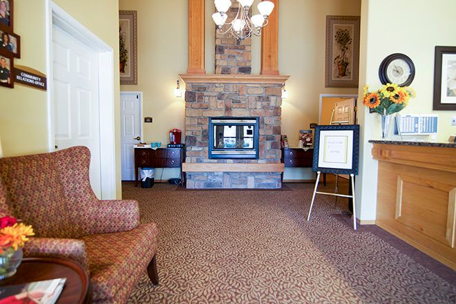 A cozy lobby featuring a stone fireplace and comfortable seating.