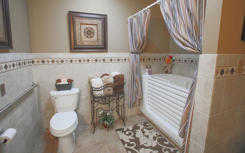 A cozy bathroom with a bathtub and decorative elements.