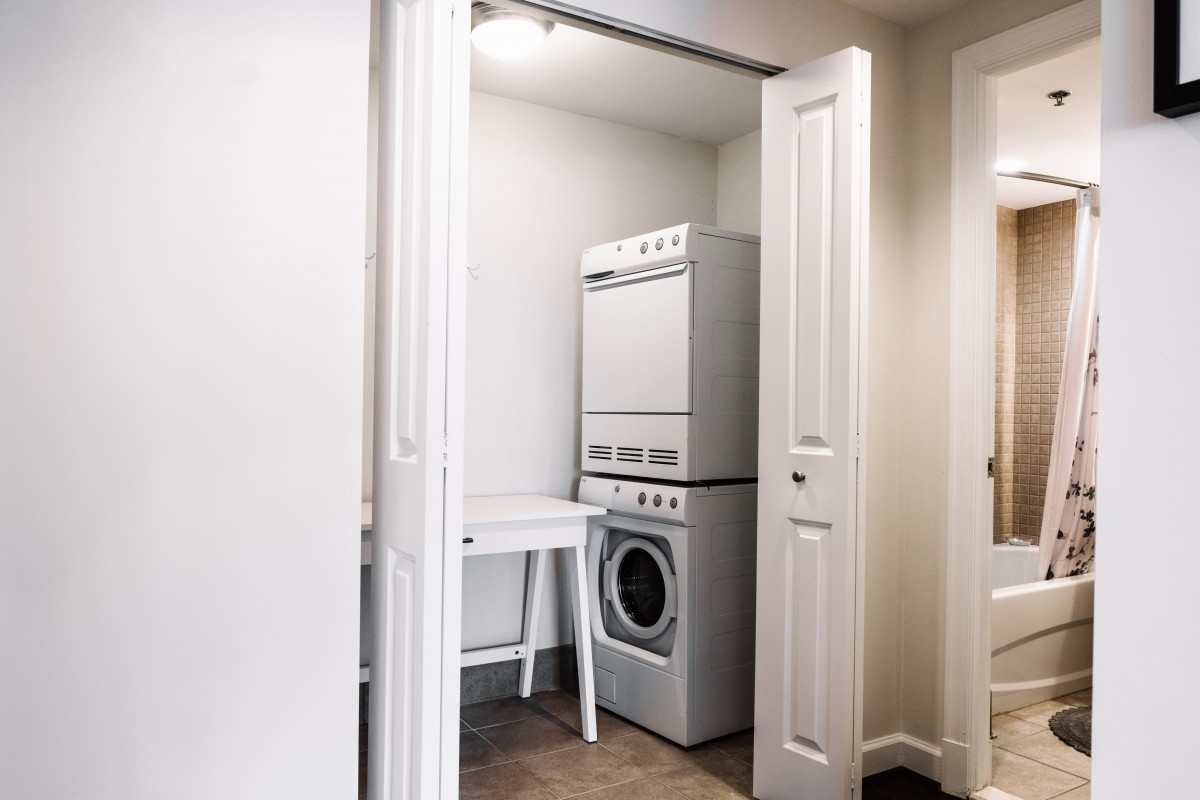 A compact laundry area with a stacked washer and dryer in a closet.