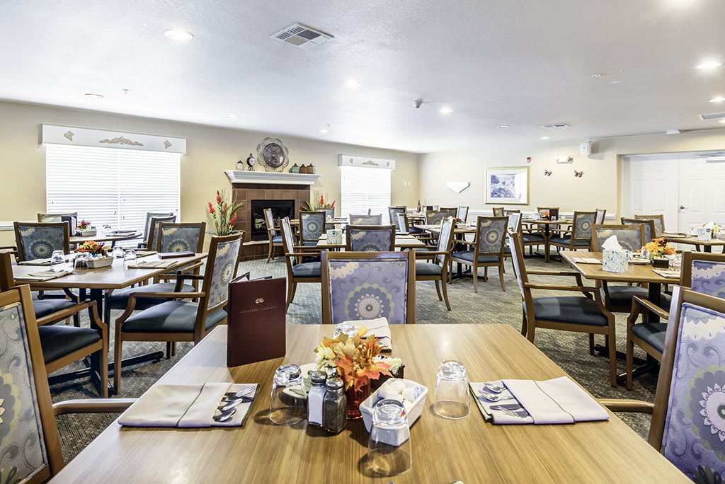 An inviting dining room setup with neatly arranged tables and chairs.