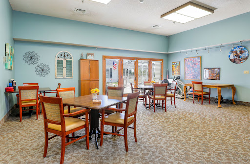 A well-lit and inviting dining area with tables and chairs, perfect for community gatherings.