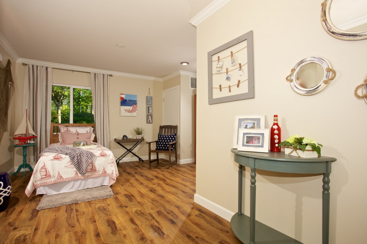 A cozy bedroom with wooden flooring and tasteful decor.