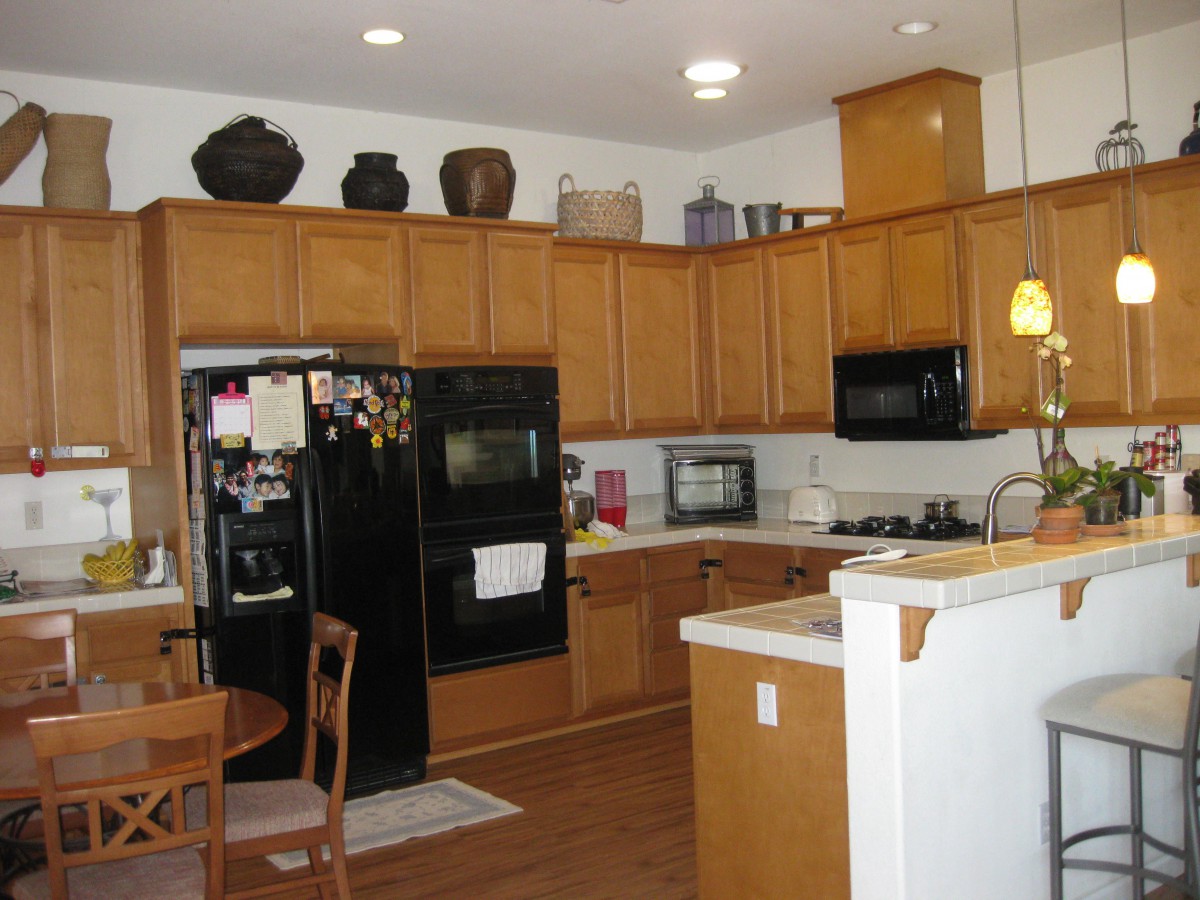 Spacious kitchen with wooden cabinets, modern appliances, and a small dining area.