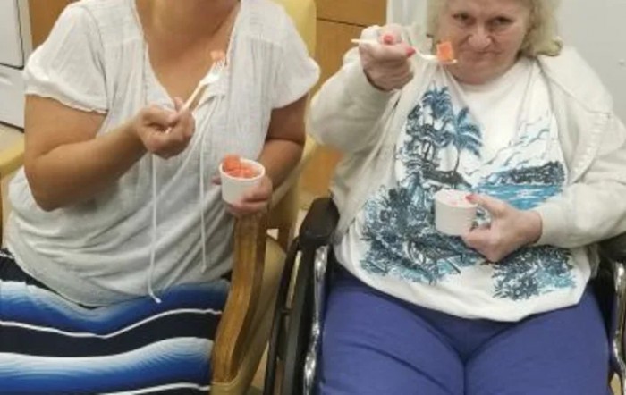 Two people enjoying ice cream indoors.