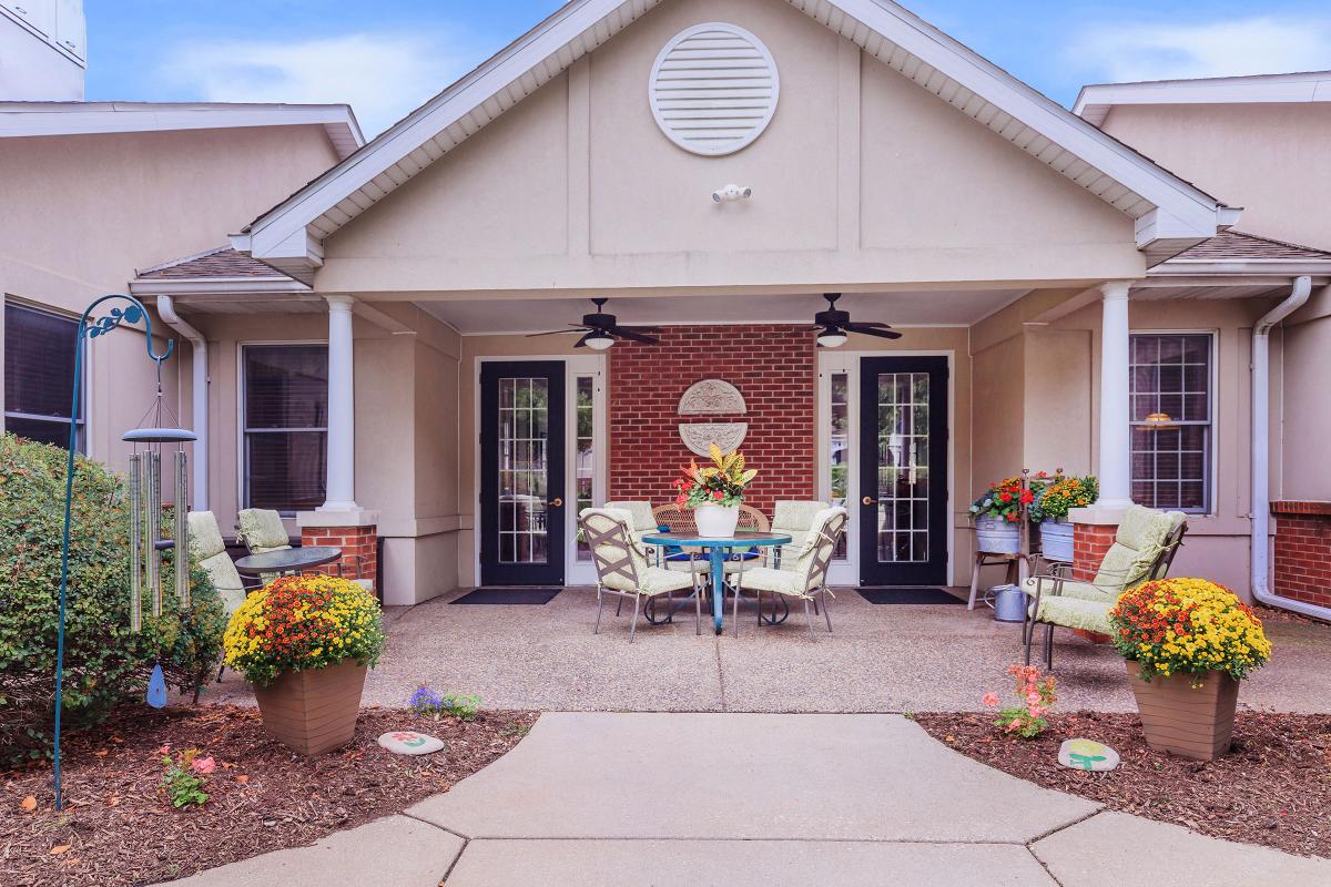 A cozy outdoor patio area with seating and decorative plants.