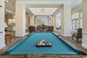 A well-lit indoor space featuring a pool table set up for a game.