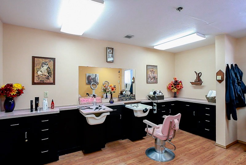 Interior of a barber shop with styling chairs, mirrors, and salon equipment.
