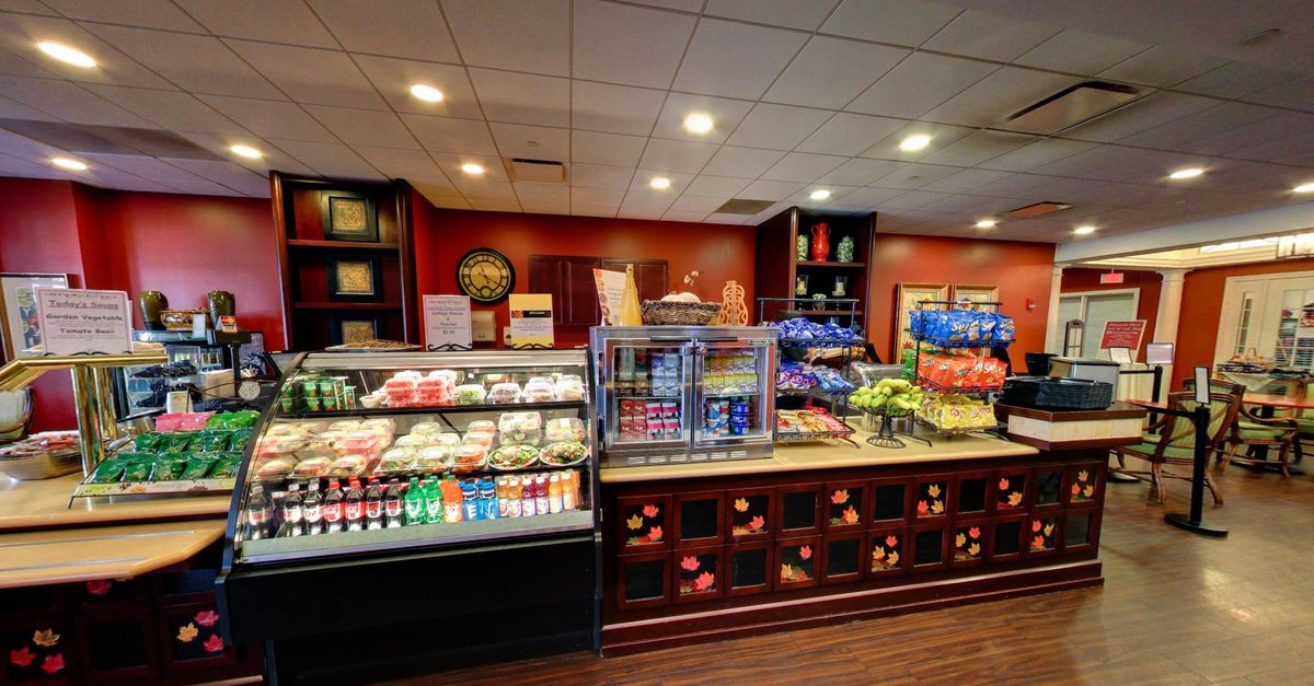 A well-organized convenience store section featuring a variety of snacks and beverages.