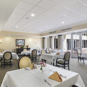 An elegant dining area with neatly arranged tables and chairs in a formal setting.
