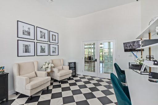 A stylish living room featuring contemporary furniture and a striking black and white checkered floor.
