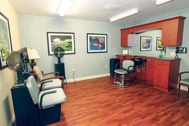 A cozy hair salon with a barber chair and waiting area.