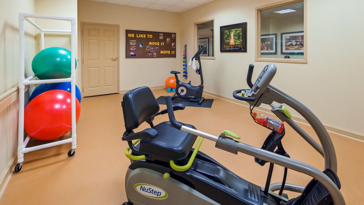 A home gym featuring stationary bikes and vibrant workout equipment for exercise.