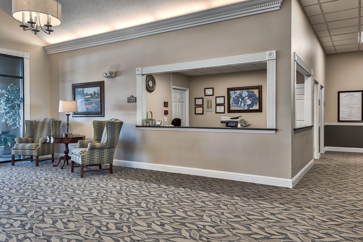 A well-appointed lobby featuring a reception desk and comfortable seating.