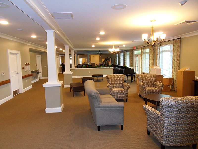 A cozy interior lounge featuring comfortable seating and a piano.