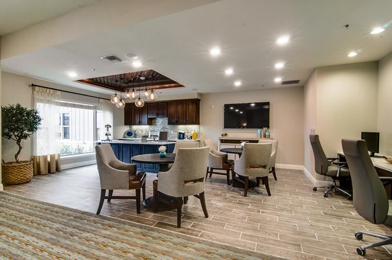 A modern living and dining area with stylish furniture and ambient lighting.