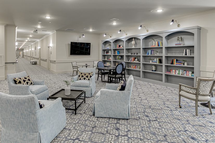 A cozy library with bookshelves and a comfortable seating area.