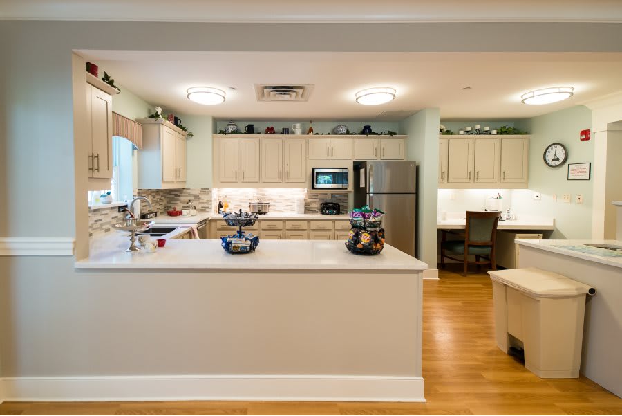 A modern kitchen with a center island and stainless steel appliances.