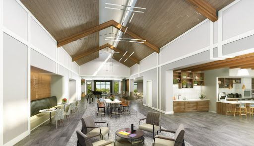 A contemporary community space featuring large windows and wooden beams, designed for gatherings and social activities.