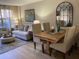 A cozy living room with a sofa and dining area featuring elegant decor.