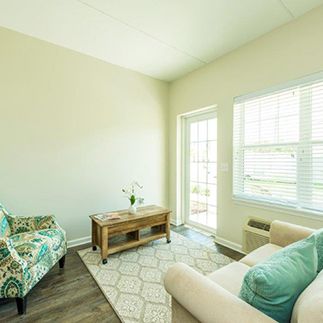 A cozy and well-lit living room with a sofa, chair, and coffee table.