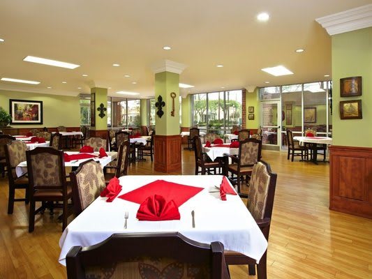 An inviting restaurant dining area with elegantly set tables and comfortable seating.