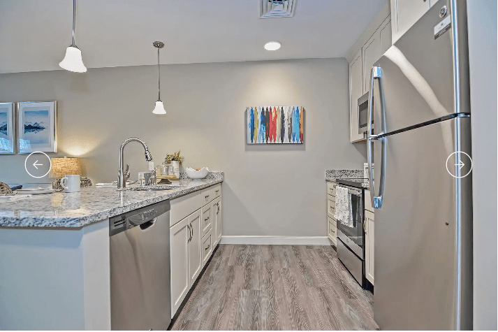 A modern kitchen with stainless steel appliances and a sleek design.