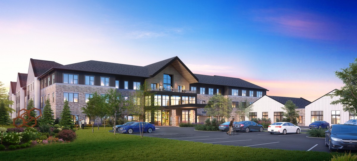 A modern residential building with parked cars at dusk.