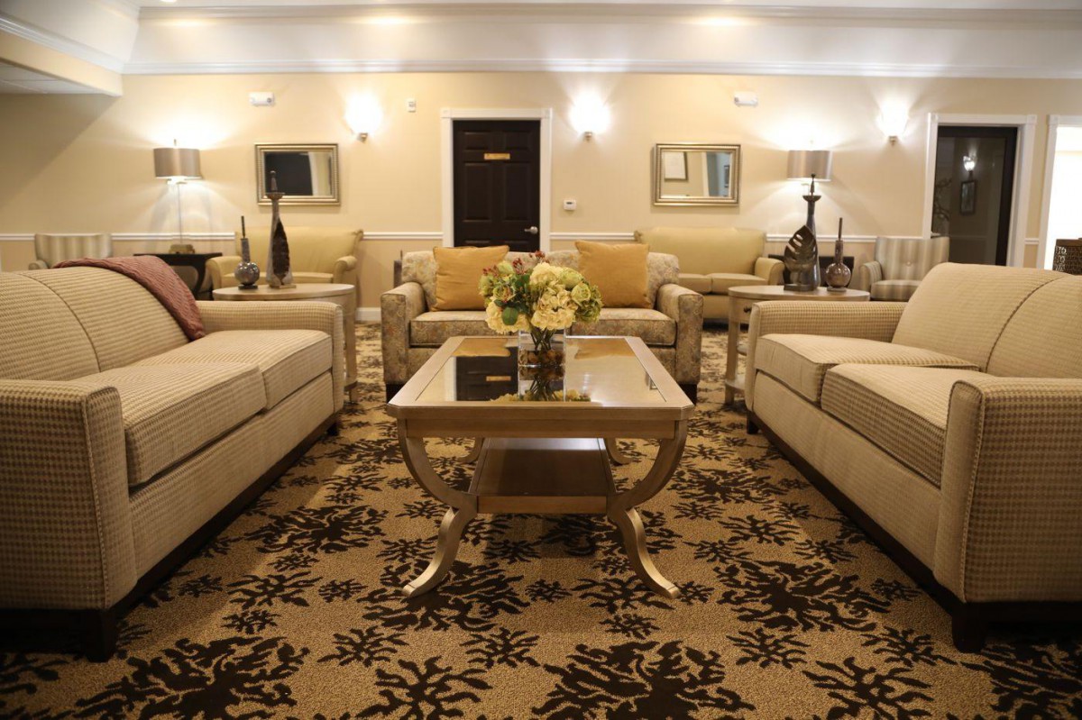 A cozy living room featuring elegant sofas, a stylish coffee table, and warm lighting.